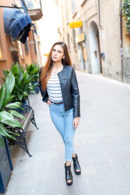 beautiful brunette Italian girl walks in the town. High quality photo