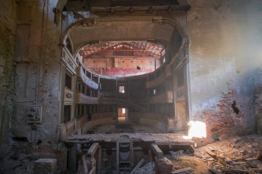 interior stage and armchairs of old decadent abandoned theater in Italy. High quality photo