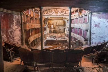 interior stage and armchairs of old decadent abandoned theater in Italy. High quality photo