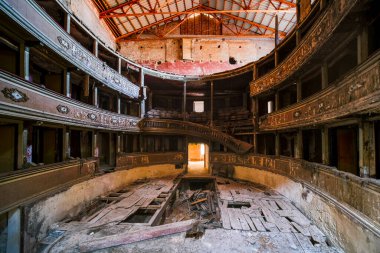 interior stage and armchairs of old decadent abandoned theater in Italy. High quality photo
