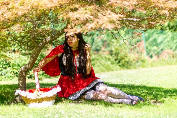 Lucca, Italy - 2018 10 31 : Lucca Comics free cosplay event around city little red riding hood sitting in the shade. High quality photo