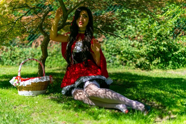 Lucca, Italy - 2018 10 31 : Lucca Comics free cosplay event around city little red riding hood sitting in the shade. High quality photo