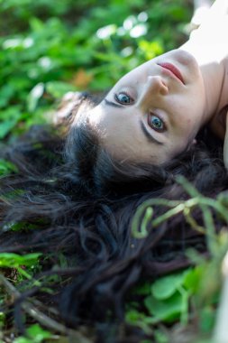beautiful Italian girl lying in the woods. High quality photo