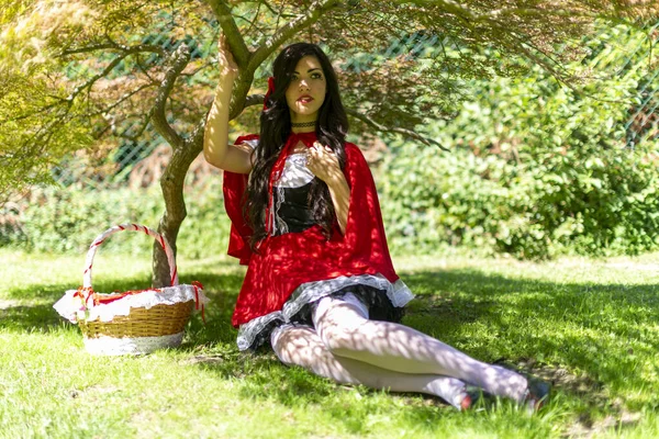 Lucca, Italy - 2018 10 31 : Lucca Comics free cosplay event around city little red riding hood sitting in the shade. High quality photo