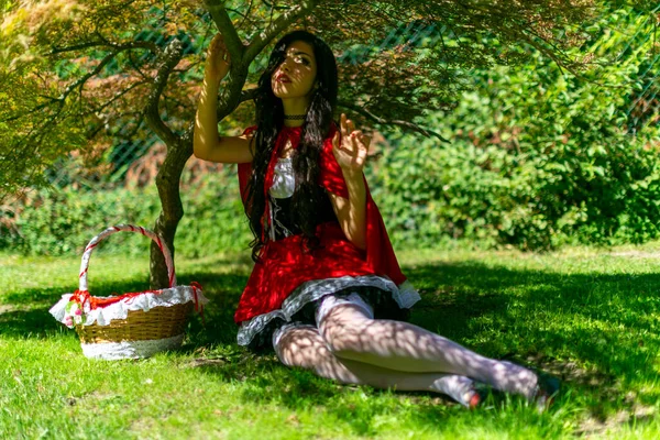 Lucca, Italy - 2018 10 31 : Lucca Comics free cosplay event around city little red riding hood sitting in the shade. High quality photo