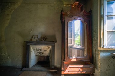 fireplace and mirror room in large abandoned house. High quality photo