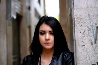 beautiful brunette Italian girl with leather jacket and jeans. High quality photo