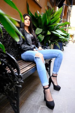 beautiful brunette Italian girl with leather jacket and jeans. High quality photo