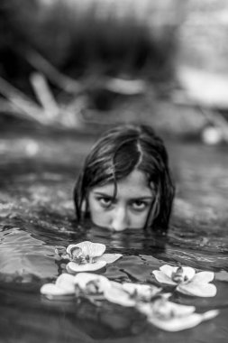 beautiful girl with open back posing on the bank of a river. High quality photo