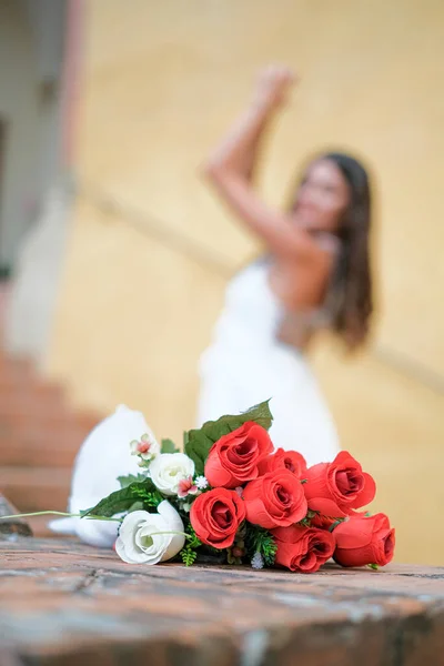 bouquet of roses with wedding couple in the background. High quality photo