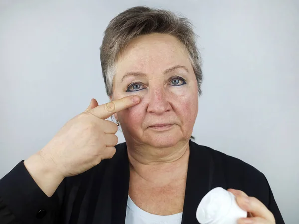Elderly Woman Applies Aging Face Cream Cosmetology Withering Aging Skin Stock Image