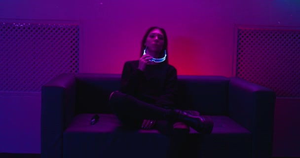 Neon style. Young woman in neon blue glasses. — Stock Video