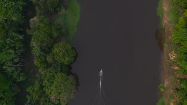 El barco flota en el río en la selva. Vista superior desde el dron. — Vídeos de Stock