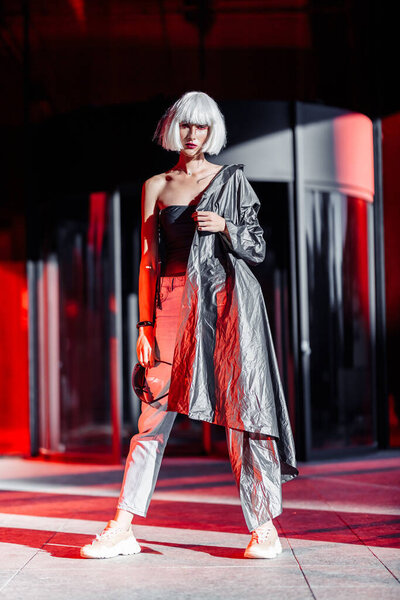 Fashion of the future. Futuristic blonde in red space.