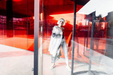 Fashionable blonde in a raincoat. High quality photo