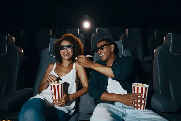 Couple watching comedy in 3d glasses with popcorn. High quality photo