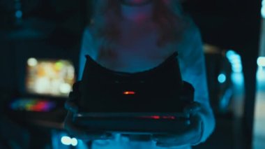 Player puts on 3d virtual reality glasses in neon style. High quality 4k footage