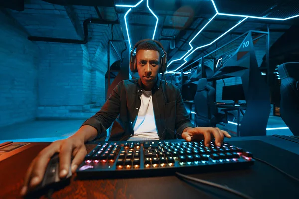 Cyber sportsman plays a computer game in a neon room.1. High quality photo