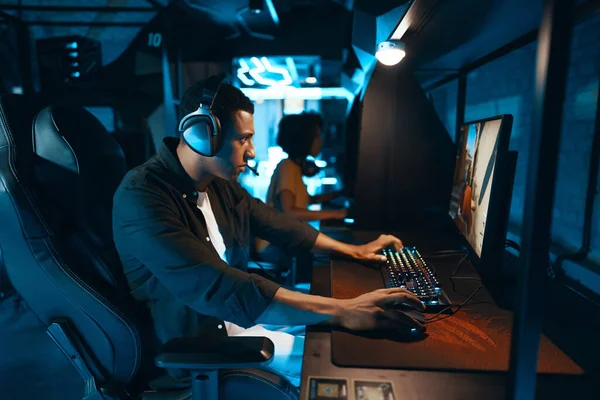 Computer player in neon cyber club playing championship. High quality photo