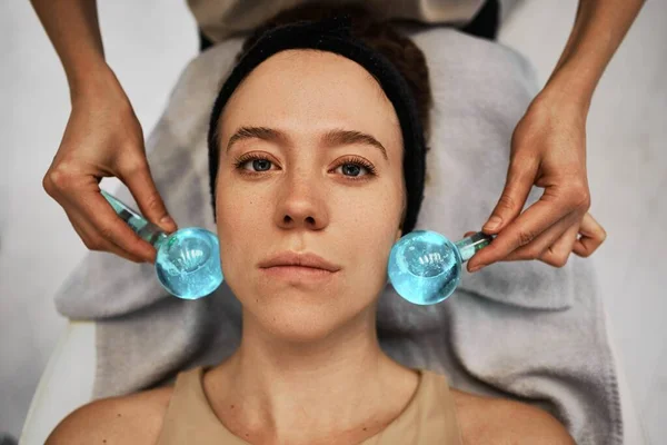 Facial massage with cold spheres. High quality photo
