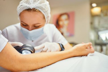 Bir dermatolog deriyi inceler. Yüksek kalite fotoğraf