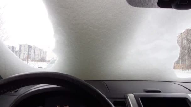 Vy från insidan av bilen torka snö vindrutan — Stockvideo