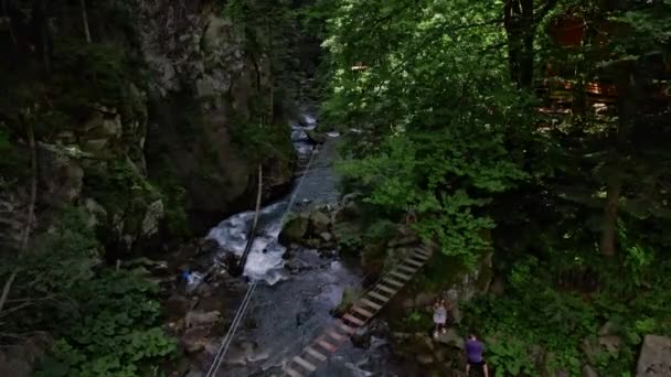 Människor på extrema park attraktion ovanför berg floden — Stockvideo