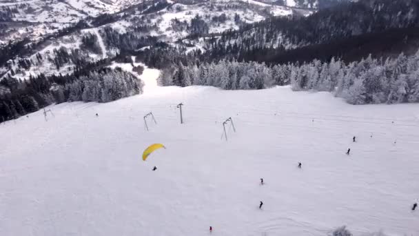 Esquiador parapente por encima de la estación de esquí — Vídeo de stock