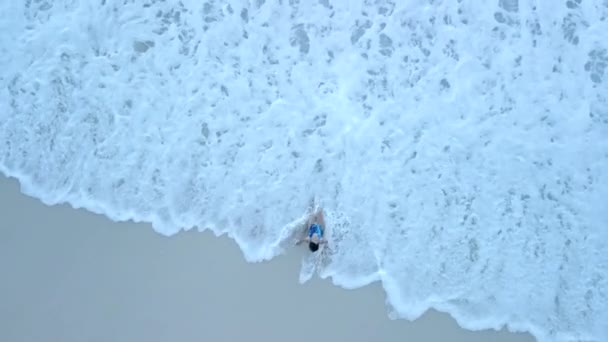 海水浴場での水着姿の女性の頭上には — ストック動画