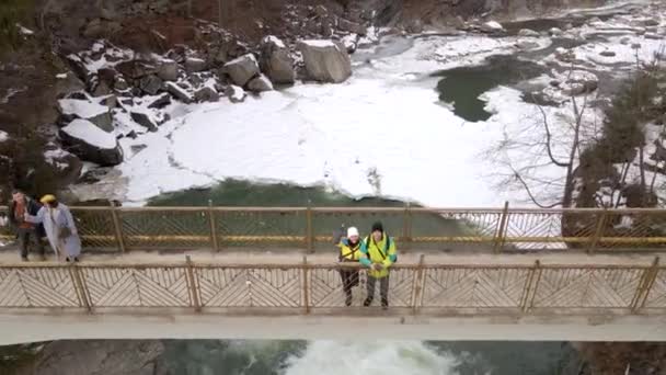 Tourists at the bridge above the waterfall — Stock Video