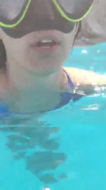 Dalgıç maskeli kadın ve dalgıç paletleri denizde yüzüyor.