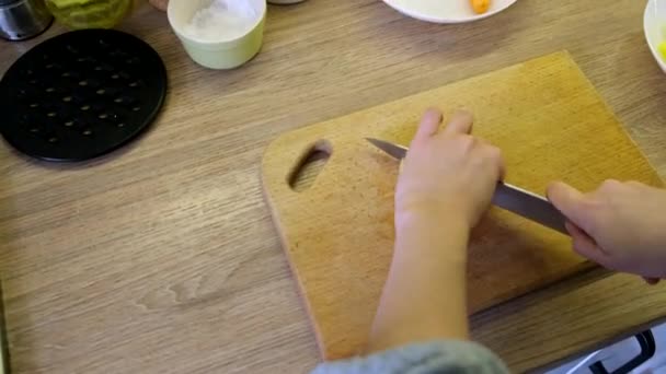 Woman slice potatoes on cut board — Wideo stockowe