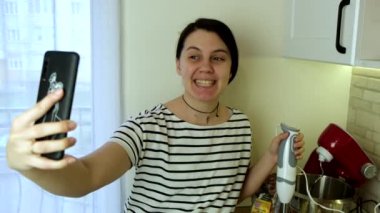 Kadın blogcu mutfak fotokopi alanında yemek programı yapıyor.