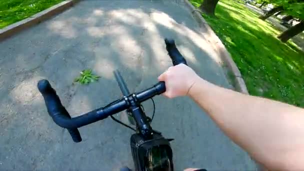 Person view driving bicycle by city street — Stockvideo