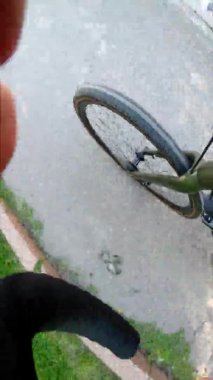 top view of front bicycle wheel riding by city wide angle