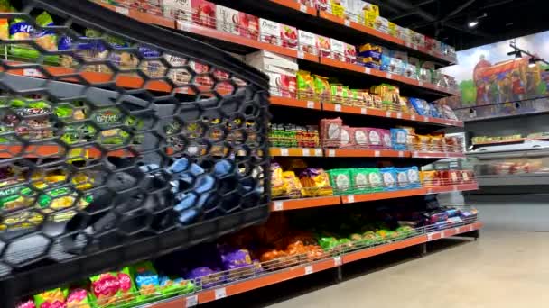 Woman Trolley Passing Groceries Shelves Lifestyle — Stockvideo