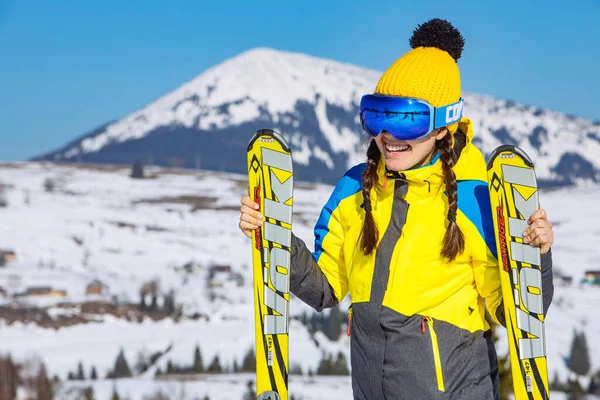 Ung Leende Vacker Kvinna Håller Skida Berg Bakgrunden Vinterresor Kopieringsutrymme — Stockfoto