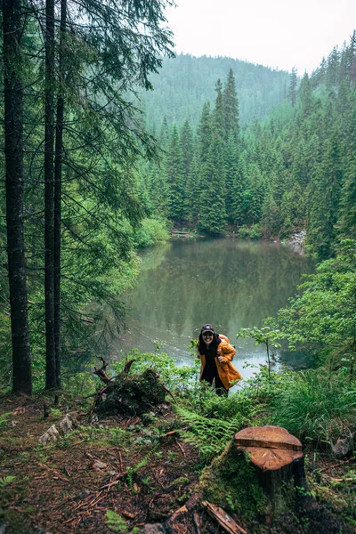 Жінка Ходить Рюкзаком Жовтому Плащі Дивлячись Місце Копіювання Гірського Озера — стокове фото
