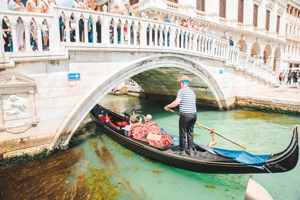Italy, Venice - May 25, 2019: people at gondola taking tour by canal — Stock Photo, Image