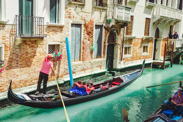 Italy, Venice - May 25, 2019: people at gondola taking tour by canal — Stock Photo, Image