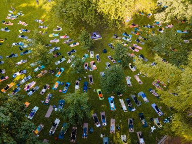 Şehir parkında yoga yapan insanların genel görünümü