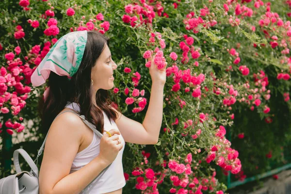 Jong Vrij Glimlachende Vrouw Buurt Bloeiende Rode Rozen Bush Kopiëren — Stockfoto