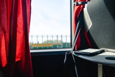 road trip travel concept electric book on the table in the bus coach