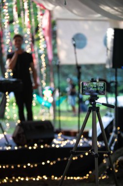 Lviv, Ukraine - July 16, 2021: live streaming on the phone of local concert copy space