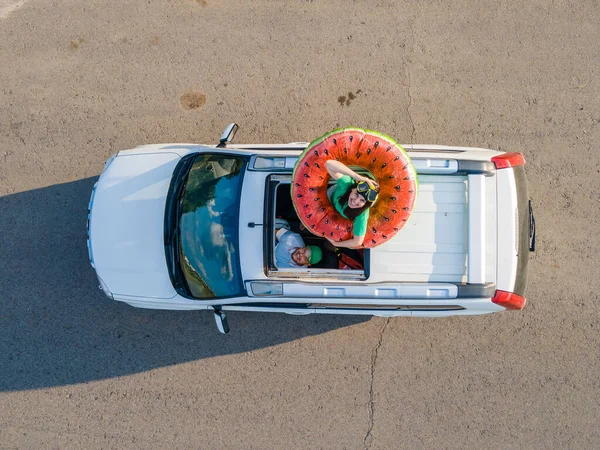 happy couple in car overhead view car travel to sea concept sunroof