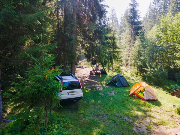 view of camping site with tent and suv car copy space