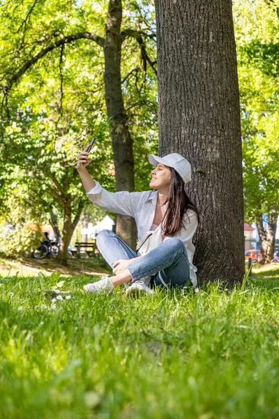 Mulher Sentada Debaixo Árvore Parque Cidade Tomando Selfie Espaço Cópia — Fotografia de Stock