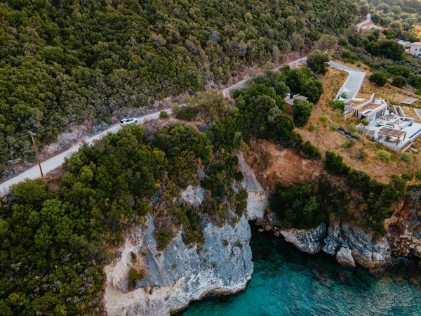 overhead view of car moving by road next to sea shore copy space