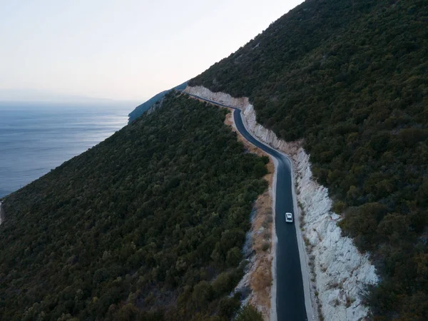 car travel concept moving by road in mountains with view of sea shore copy space