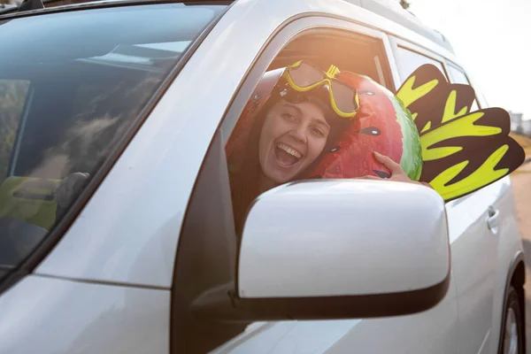 sea car travel trip smiling woman driver in car full of vacation stuff copy space